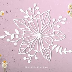 the paper snowflake is cut out and placed next to some flowers on a pink background