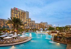 an outdoor swimming pool surrounded by tall buildings