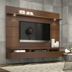 a living room with a large tv mounted to the side of it's wall