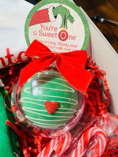 a christmas ornament in a box with candy canes