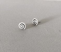 Small spiral stud earrings made of silver 925. Spiral is one of the oldest symbols used by mankind. It appears ever since the Paleolithic era in Greece. This complicated but so powerful symbol is to be found everywhere in many ancient civilizations all around the world as well, as a symbol of the living force.Above all and especially in Greece it has always been a sign and a symbol of the Ancient Greek spirit and the Ancient Greek living force. It declares as a historic symbol the Greek origin o Minimalist Silver Swirl Earrings, Minimalist Sterling Silver Swirl Earrings, Minimalist Swirl Earrings As Gift, Minimalist Swirl Earrings Gift, Diy Earrings Studs, Paleolithic Era, Hip Jewelry, Spiral Jewelry, Earrings Cool