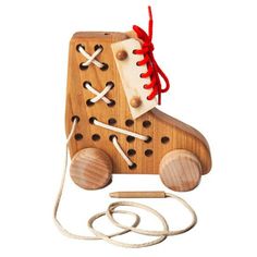 a wooden toy that has been made to look like a roller skate with laces on it