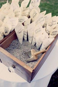 a wooden box filled with lots of papers and shovels on top of a table