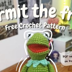 a crocheted frog doll sitting on top of a wooden table with text overlay