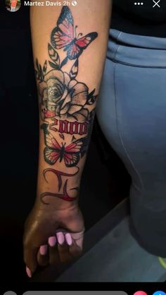 a woman's arm with tattoos on it and butterflies flying over the top of her wrist