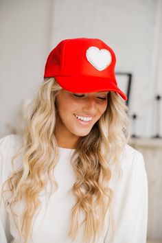 The cutest trucker hats featuring a white heart patch! Boys Denim Jacket, Style Themes, Cherry Shirt, Crochet Jumpsuits, Striped Flare Pants, Brown Tunic, Embroidered Hearts, Custom Trucker Hats, Heart Patch