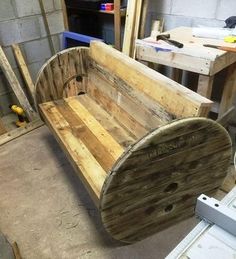 a wooden bench made out of pallets in a workshop