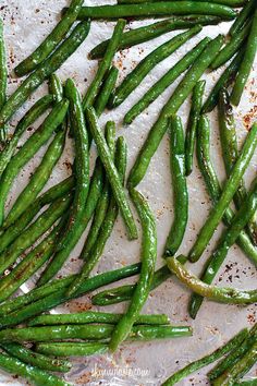 green beans on a baking sheet ready to be cooked in the oven for roasting