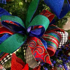 a christmas tree decorated with red, white and blue ribbons