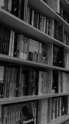 a bookshelf filled with lots of books next to each other