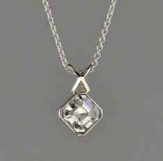 "18 kt white gold pendant. Set with 1.05 carat Asscher cut F-VS2 diamond. The Diamond can be upgraded in size or quality or lesser size and quality. The pendant comes with an 18 kt 1.1 mm 16\" cable chain.  The Diamond is certified." White Asscher Cut Jewelry With Bezel Setting, Elegant Silver Asscher Cut Solitaire Necklace, Asscher Cut Solitaire Necklace With Diamond Accents, Silver Solitaire Necklace With Rose Cut Diamonds, Silver Solitaire Necklace With Rose Cut Diamonds For Gift, Silver Jewelry With Asscher Cut And Bezel Setting, Silver Jewelry With Asscher Cut Bezel Setting, Silver Jewelry With Bezel Setting And Asscher Cut, Silver Asscher Cut Jewelry With Bezel Setting