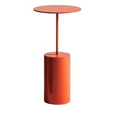 an orange table with a round top and metal stand on the bottom, against a white background