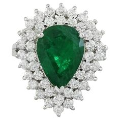 5.80 Carat Natural Emerald 14 Karat Solid White Gold Diamond Ring Stamped: 14K Total Ring Weight: 6.3 Grams Emerald Weight 4.30 Carat (13.00x9.00 Millimeters) Diamond Weight: 1.50 carat (F-G Color, VS2-SI1 Clarity ) Quantity: 34 Face Measures: 22.85x18.65 Millimeter SKU: [600530] Luxury Pear-shaped Diamond Ring With 17 Jewels, Formal Gia Certified Cluster Ring, Luxury Pear-shaped Emerald Ring For Formal Occasions, Luxury Pear-shaped Emerald Ring With Prong Setting, Gia Certified Cluster Diamond Ring For Formal Occasions, Formal Pear-shaped Emerald Ring In White Gold, Luxury Pear-shaped Brilliant Cut Emerald Ring, Formal Pear-shaped Emerald Ring With Diamond, Formal Gia Certified Pear-shaped Rings