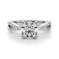 a white gold engagement ring with an oval cut diamond in the center and two side stones on