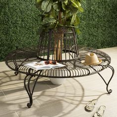 Inspired by one of London’s legendary public squares, this outdoor Ally Tree Bench blends classic, romantic style with ample seating. Finished in rustic brown, Ally's curved iron scrolls lend elegant character to any garden or grounds. Safavieh Ally 60.25-in W x 33.75-in H Rustic Brown Wrought Iron Garden Bench | PAT5019A Outdoor Tree Bench, Boom Bank, Bench Around Trees, Metal Outdoor Bench, Classic Romantic Style, Tree Bench, Iron Bench, Outdoor Trees, Metal Bench