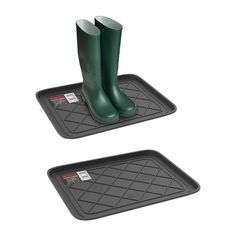 two rubber mats with green boots on them