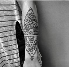 a woman's arm with a tattoo design on the left side of her body