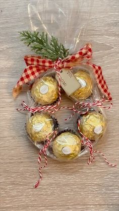 four chocolates wrapped in cellophane and tied with ribbon