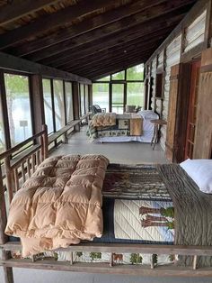 a bed room with two beds covered in blankets and pillows on top of it's sides