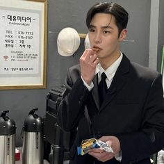 a man in a suit is eating something