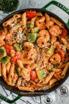 a skillet filled with pasta and vegetables