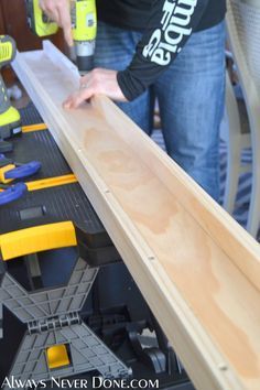 a woman is working on some wood