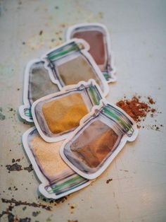 four different colored spices sitting on top of each other