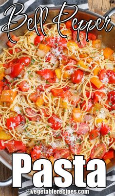 a pan filled with pasta and tomatoes on top of a wooden table