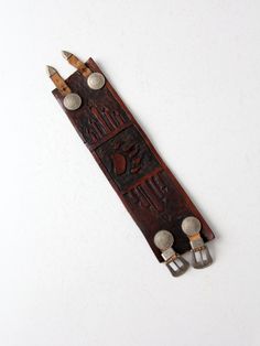 "This is a 1970s vintage tooled leather cuff bracelet. The thick russet brown leather cuff has a bear claw central design. Two leather straps close the cuff with etched silver tone buckles.  CONDITION In good condition with wear consistent with age and use. There is one small spot in the leather on back that is cracked (does not go through). See photos.  MEASUREMENTS Length:            9.25\"      ..    23.5 cm Width:              2.375\"    ..    6 cm    Strap Length:  8.5\"       ...      21.6 Vintage Hand-tooled Leather Cuff Bracelet, Vintage Leather Bracelet With Concho, Rustic Hand Tooled Adjustable Belt Buckles, Rustic Brown Concho Bracelets, Rustic Brown Bracelet With Concho, Vintage Hand-tooled Brown Jewelry, Vintage Brown Hand-tooled Jewelry, Vintage Leather Concho Bracelets, Rustic Leather Concho Bracelets