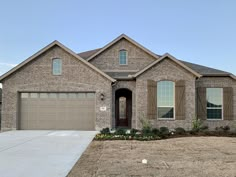 a large brick house with two garages in the front