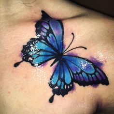 a blue butterfly tattoo on the chest