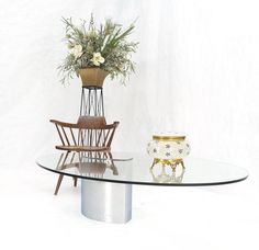 a glass table topped with a vase filled with flowers