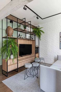 a living room filled with furniture and plants