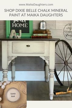 a white table with a wheel on it and some books in front of it, along with the words shop dixie belle chalk mineral paint at maka daughters