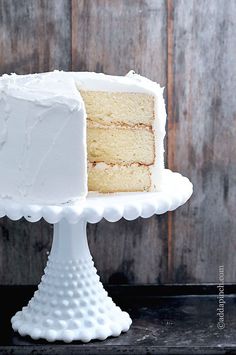 a white cake sitting on top of a white pedestal