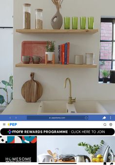 an image of a kitchen with shelves on the wall and various items on the counter