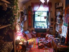 a living room filled with lots of furniture next to a large window and bookshelf