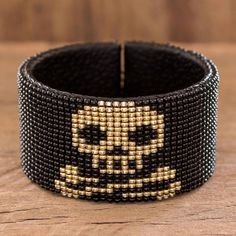 Cultivate your Gothic side with this cool cuff bracelet from the Santiago Atitlan Women's Group in Guatemala. The cuff is crafted from black leather and covered with tiny glass beads that form a golden skull and crossbones on a black background. Imperial Leather, Handmade Gifts For Boyfriend, Grunge Jewelry, Leather Cuff Bracelet, Beaded Cuff Bracelet, Buy Bead, Bracelet Leather, Beaded Cuff, Black Skulls