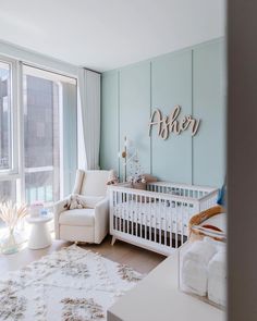 a baby's room with a white crib and blue walls