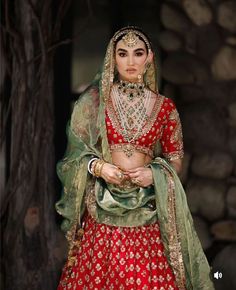 a woman in a red and green lehenga