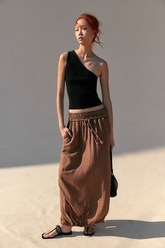 *The* perfect wear-everywhere skirt, this breezy style features a cinch band detail at the hem for added dimension. **Fit:** Mid-rise, parachute silhouette **Features:** Pull-on waistband with drawstring feature, back vented hem, banded hem, soft linen blend **Why We ❤ It:** Toughened-up with moto boots or off duty with simple sandals, you’ll be reaching for this from season to season. | Daphne Maxi Skirt by Free People in Brown, Size: XS Drawstring Skirt Outfit, Brown Long Skirt Outfit, Parachute Silhouette, Roman Plaster, Long Brown Skirt, Breezy Style, Class Dress, Maxi Skirt Style, Casual Work Wear