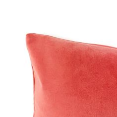 a red pillow sitting on top of a white table