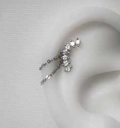 a pair of ear piercings on top of a white object