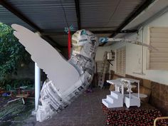 there is a giant bird made out of newspapers