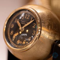 an antique clock is sitting on a stand