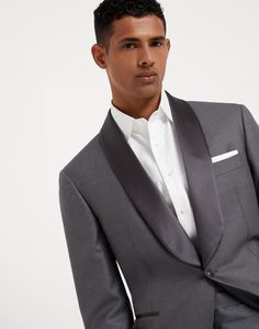 Lightweight virgin wool and silk twill tuxedo with shawl lapel jacket and pleated trousers Brunello Cucinelli style interprets the timeless elegance of the tuxedo in a modern and elegant way. The lightweight virgin wool and silk twill offers its characteristic soft, smooth texture combined with the classic shiny look of the silk and cotton satin lapel. The construction of the jacket highlights the male physique, with a close-fitted chest and slightly pronounced shoulders. In the trousers, the fa Shawl Collar Tuxedo, Brunello Cucinelli Men, Lapel Jacket, Tuxedo Shirts, Pleated Trousers, Tuxedo For Men, Tapered Trousers, Tuxedo Jacket, Male Physique