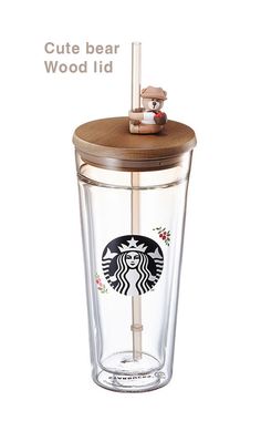 a starbucks cup with a wooden lid and straw in the shape of a bear on top