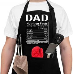 a man wearing an apron and cooking utensils with the words dad written on it