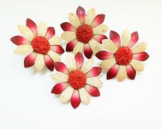 three red and white flowers on a white background