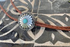 "This awesome bolo tie has a southwestern design and turquoise centerpiece. Our bolos pair nicely with many of our belt buckles! They make wonderful gifts. The western bolo tie rope length is 100cm(39\")" Southwestern Adjustable Turquoise Bolo Ties, Bohemian Adjustable Bolo Ties With Concho, Artisan Turquoise Bolo Ties With Concho, Bohemian Bolo Tie With Concho, Southwestern Concho Bolo Tie For Ranch, Adjustable Southwestern Bolo Tie, Southwestern Bolo Ties With Concho For Ranch, Southwestern Brown Concho Bolo Tie, Southwestern Concho Bolo Tie As Gift